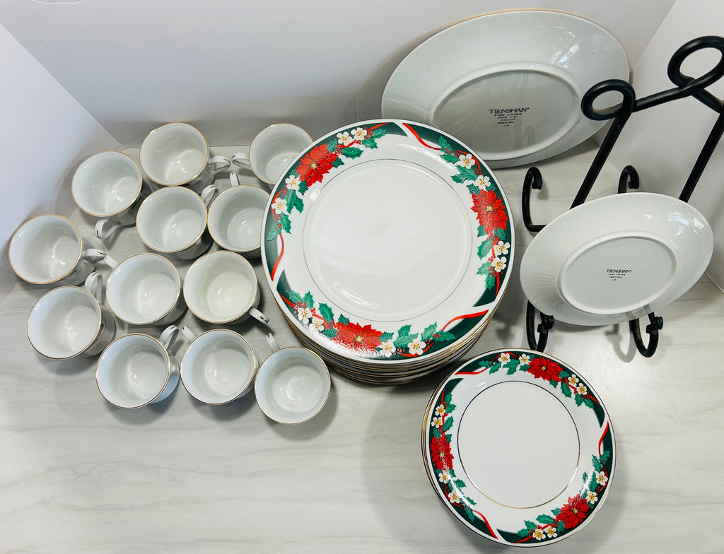 Set of white ceramic plates with floral designs on a white surface
