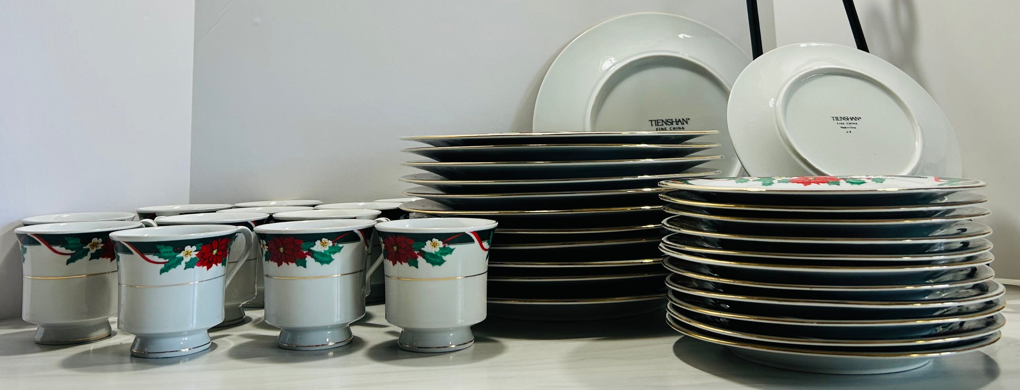 Set of plates and cups on a white surface with a neutral background